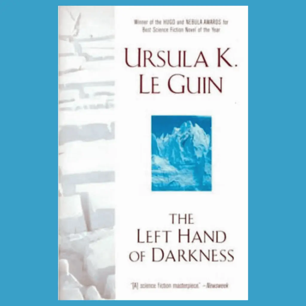 The Cover of Ursula K. Le Guin's The Left Hand of Darkness features a desert landscape with deep cracks and an abstract blue artwork that may be an ice sculpture.