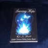 A paperback copy of Leaving Hope. On the cover, three crystalline blue butterflies emerge out of a fiery blue portal. Text: "Leaving Hope; R.L.S. Hoff; Golden Terrace Colony Series Book 1"